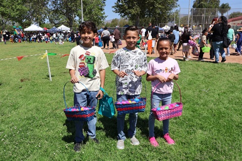 Spring Jamboree photo of three children holding Easter baskets